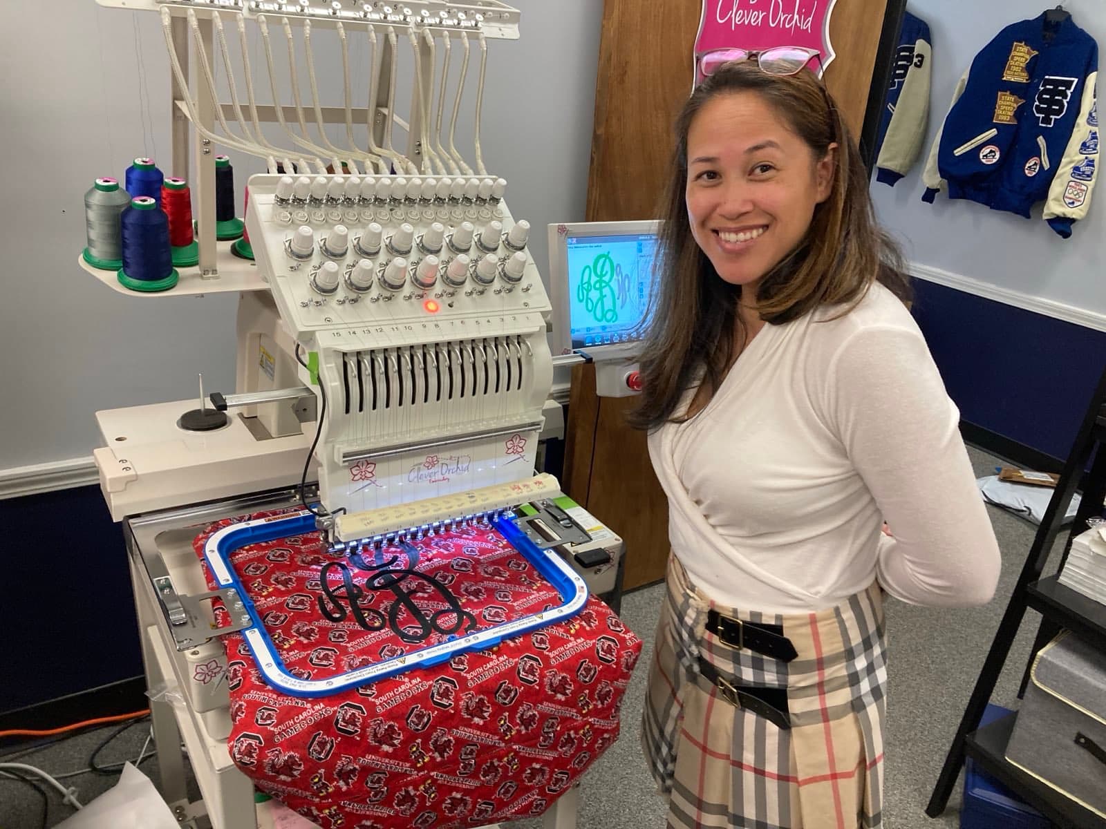Shirly at the Clever Orchid commercial embroidery machine.